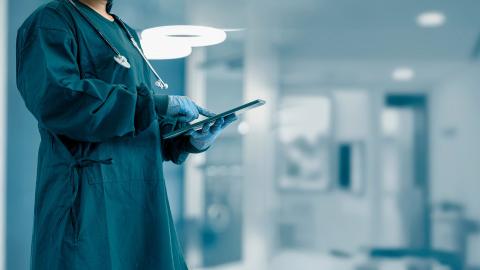 a surgeon using a tablet device