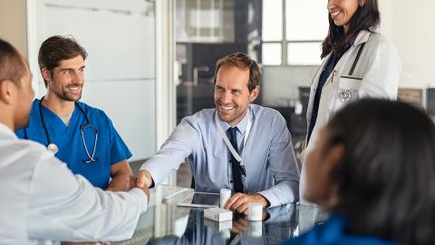 a happy patient shaking the hand of his doctor