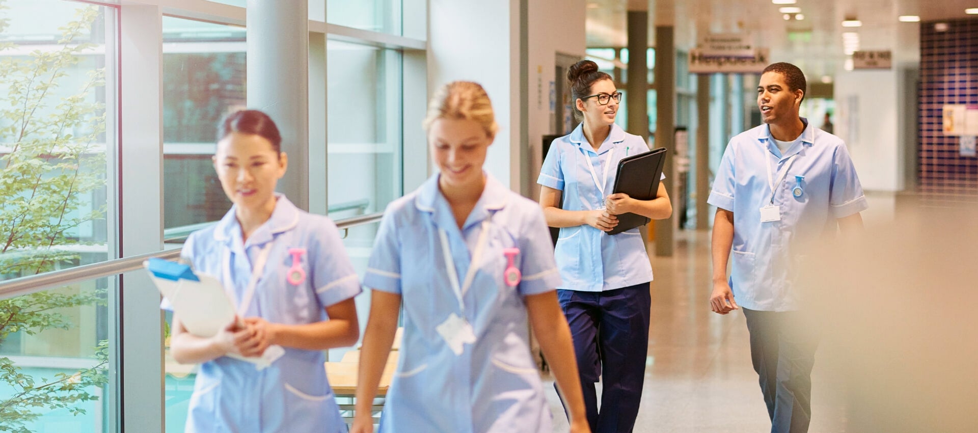 Group of nurses walking to clinical.